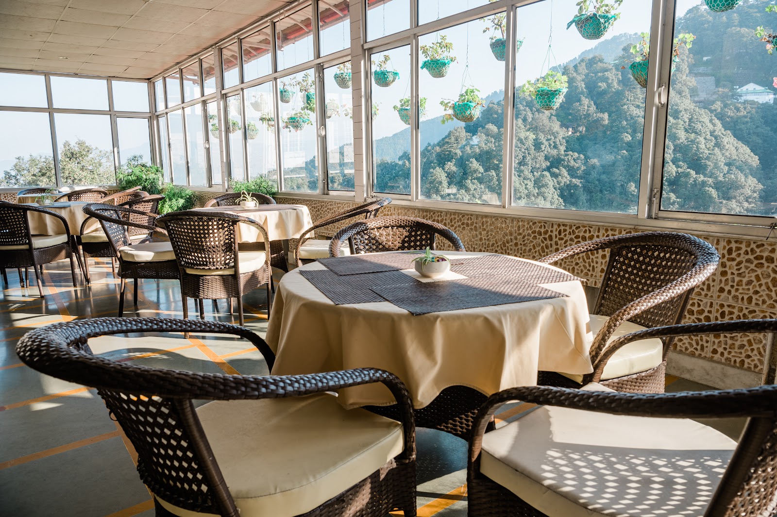 Tables by the windows at Deodar Kitchen, Mussoorie